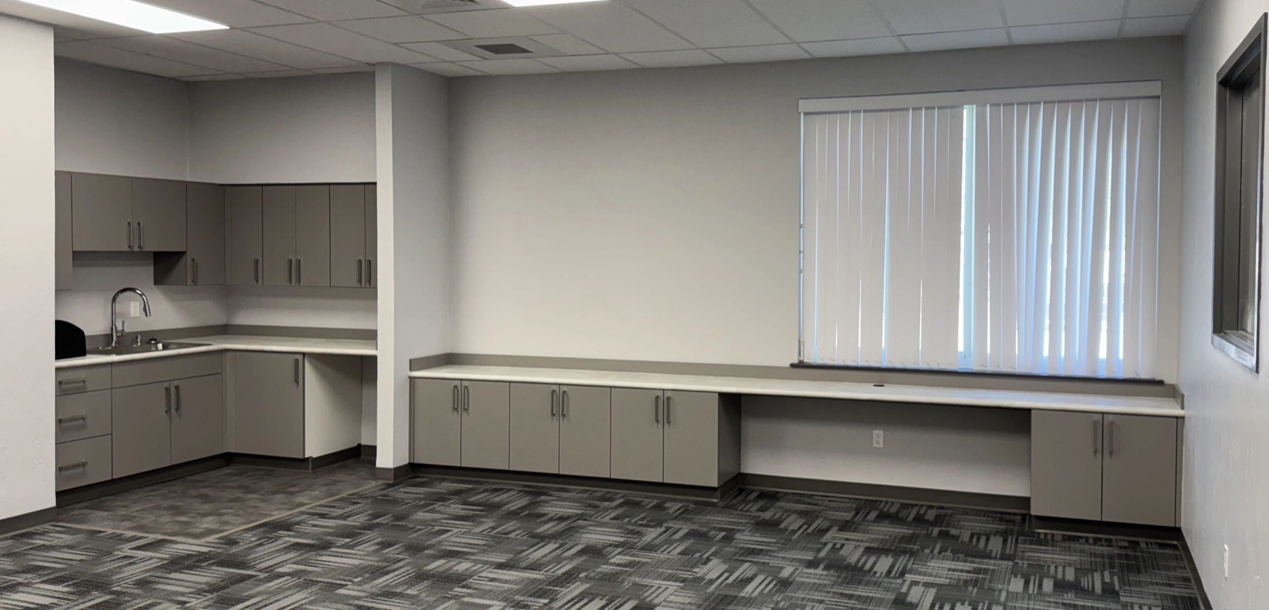 Commercial office cabinetry with long counter run
