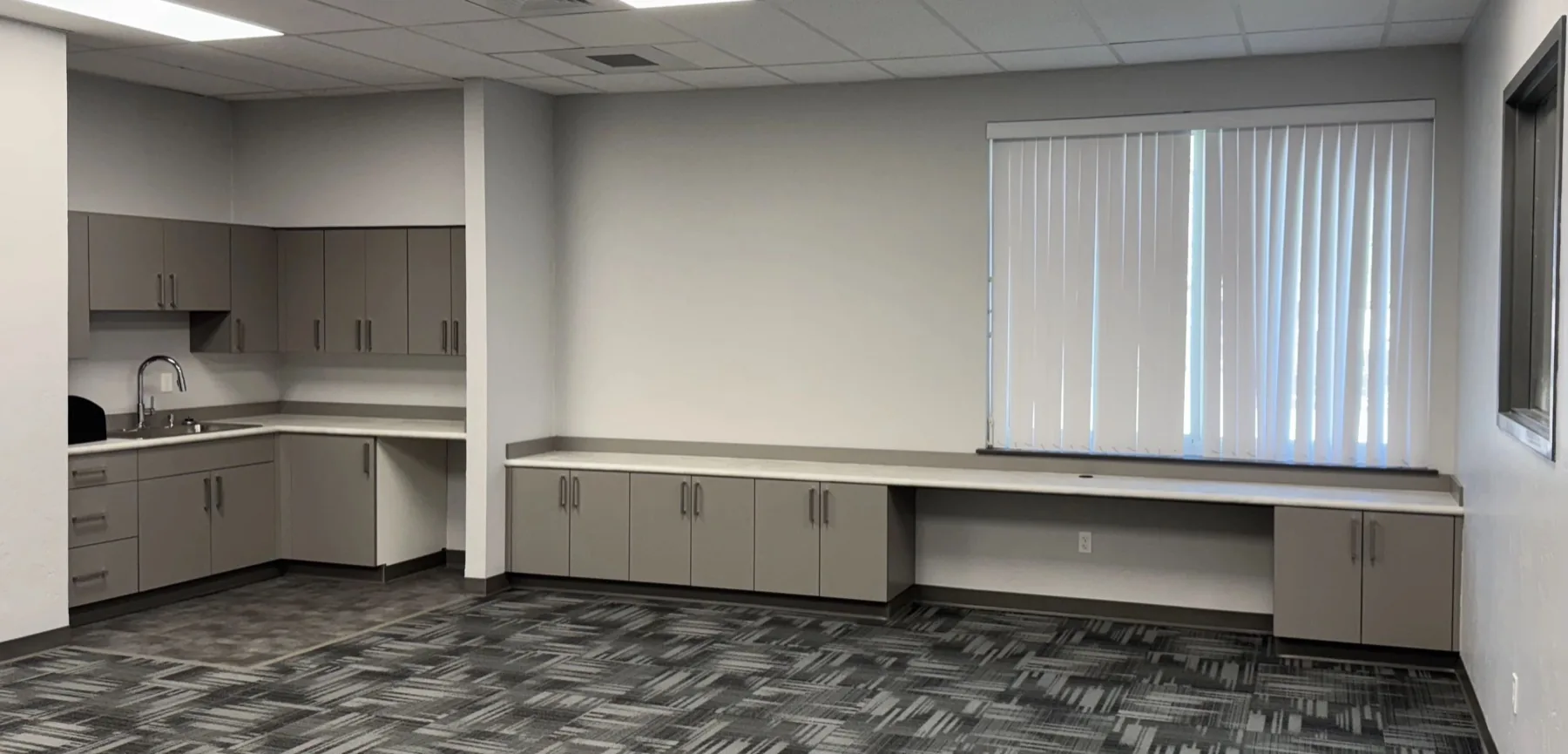 Commercial office cabinetry with long counter run