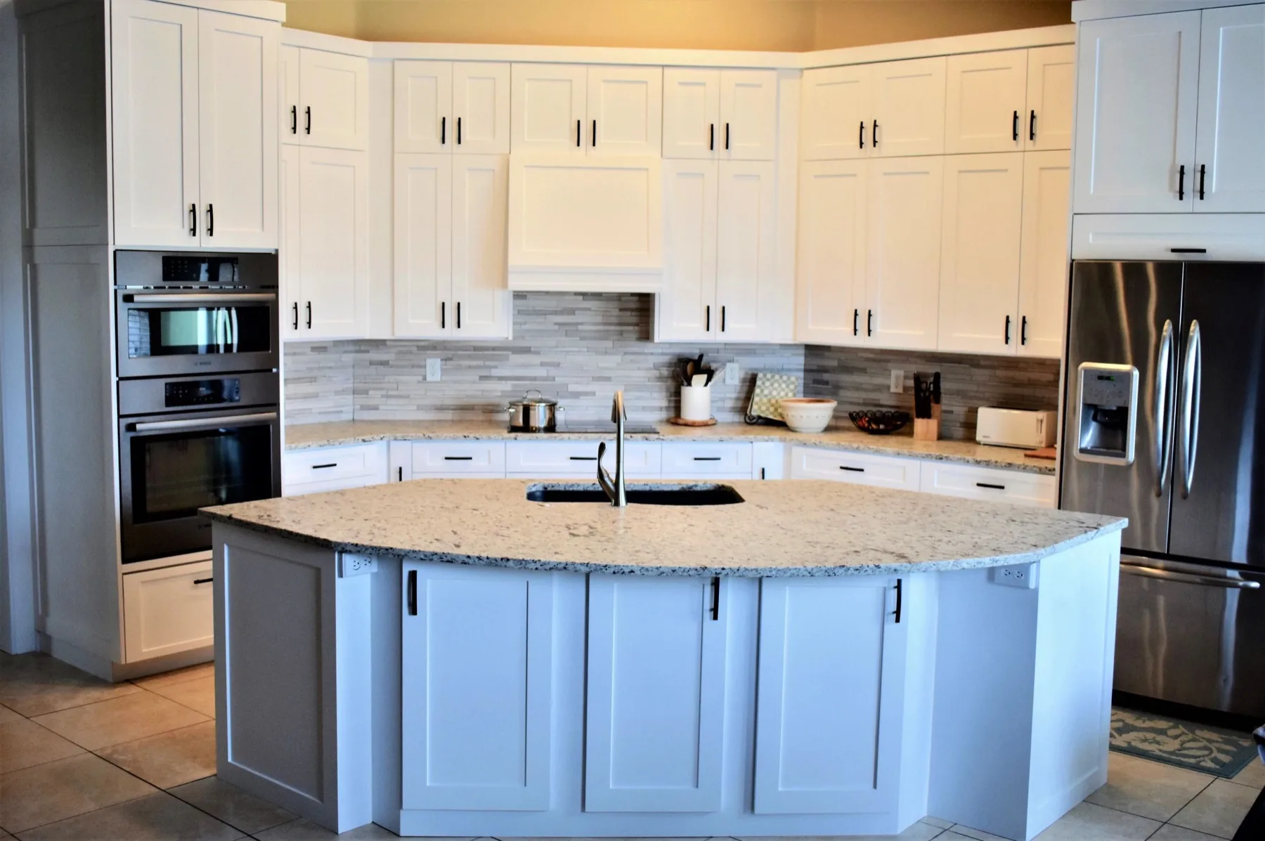 Painted shaker kitchen with a wraparound island, built by Idaho Custom Cabinets